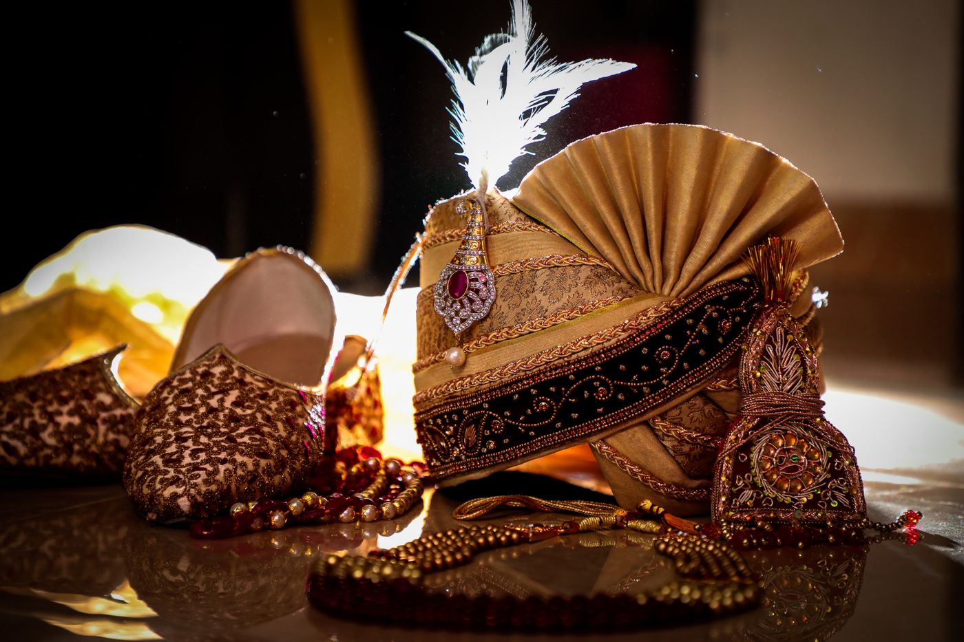 Gold safa with kalgi and feather, mala and embroidered mojari