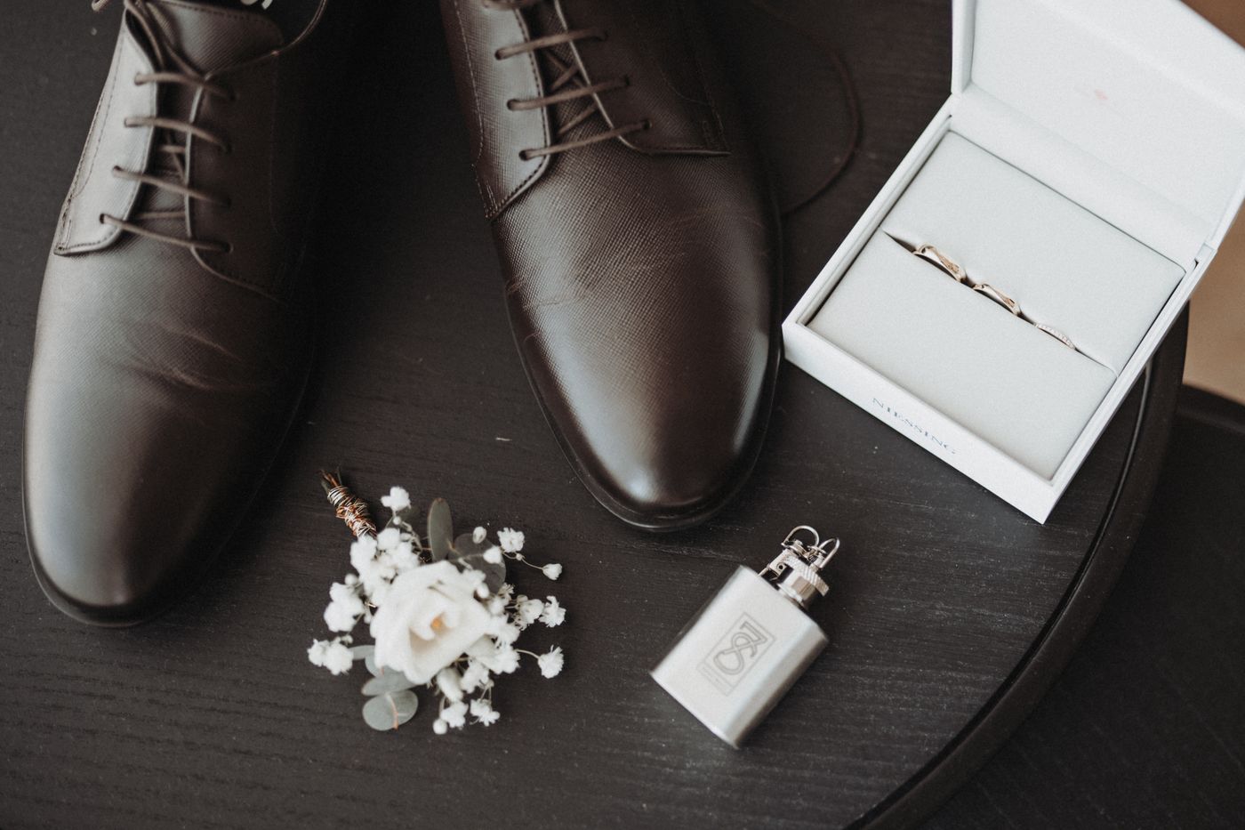 Formal shoes with boutonniere and an open ring box