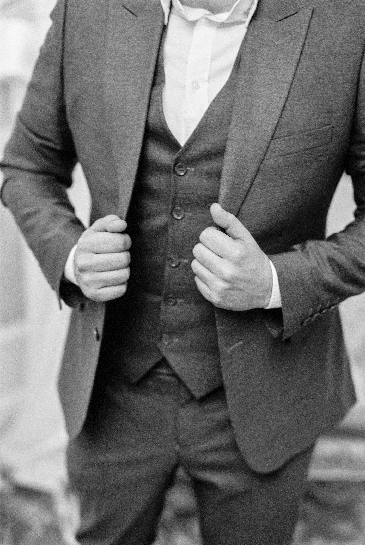 Close-up of a fitted jacket and waistcoat showing lapel and button stance